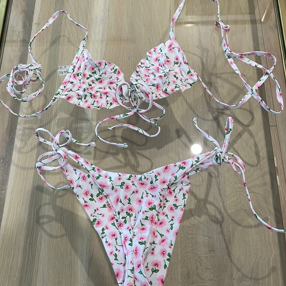 Floral bikini. White background with pink flowers. Cute tie front